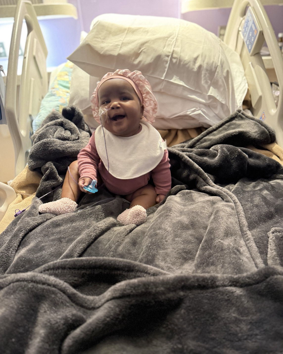Kylie smiling in bed